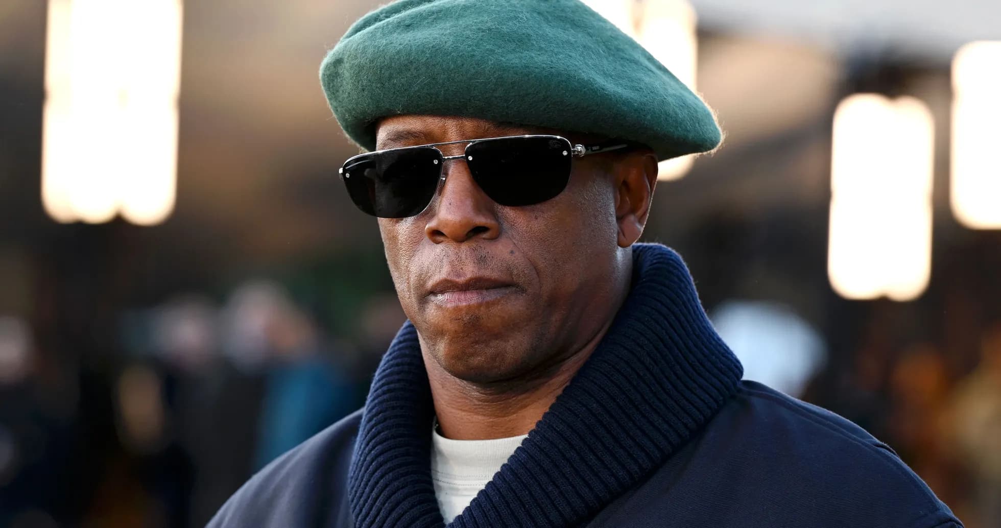 Man wearing sunglasses and green beret outdoors