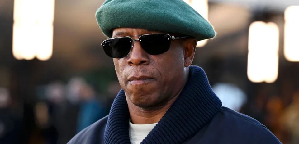 Man wearing sunglasses and green beret outdoors