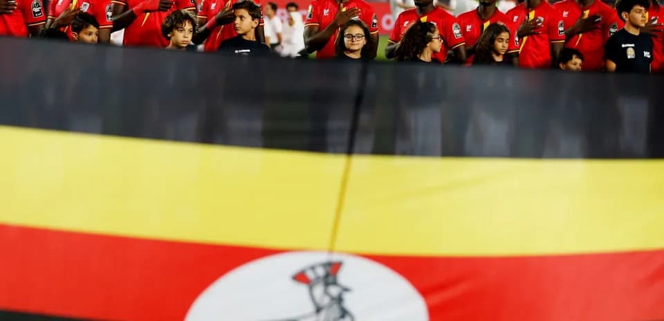 Players and children with Ugandan flag during anthem