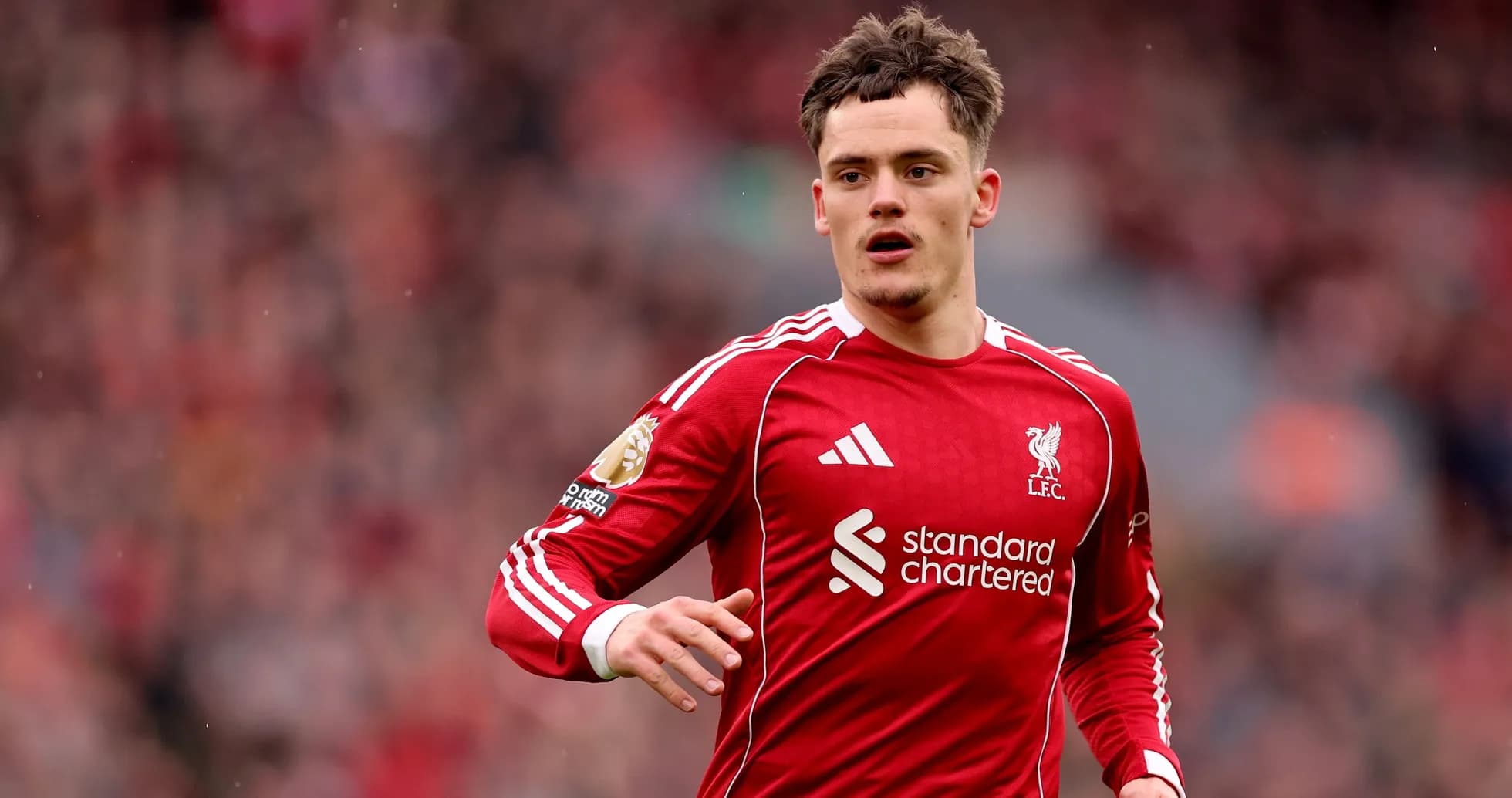 Player in red Liverpool kit running on pitch