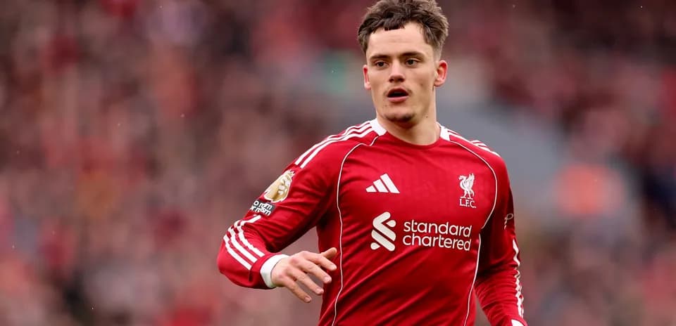 Player in red Liverpool kit running on pitch