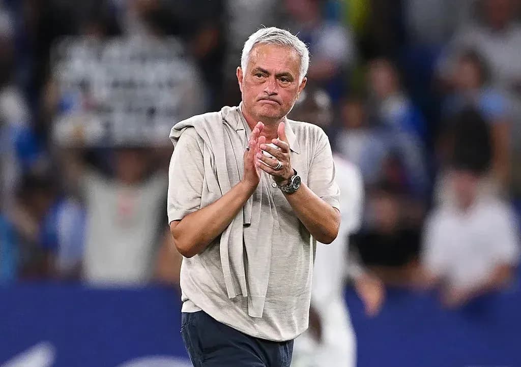 Coach applauding fans after a match