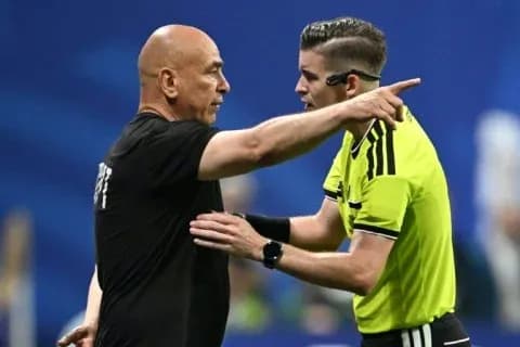 Referee discussing a decision with team manager