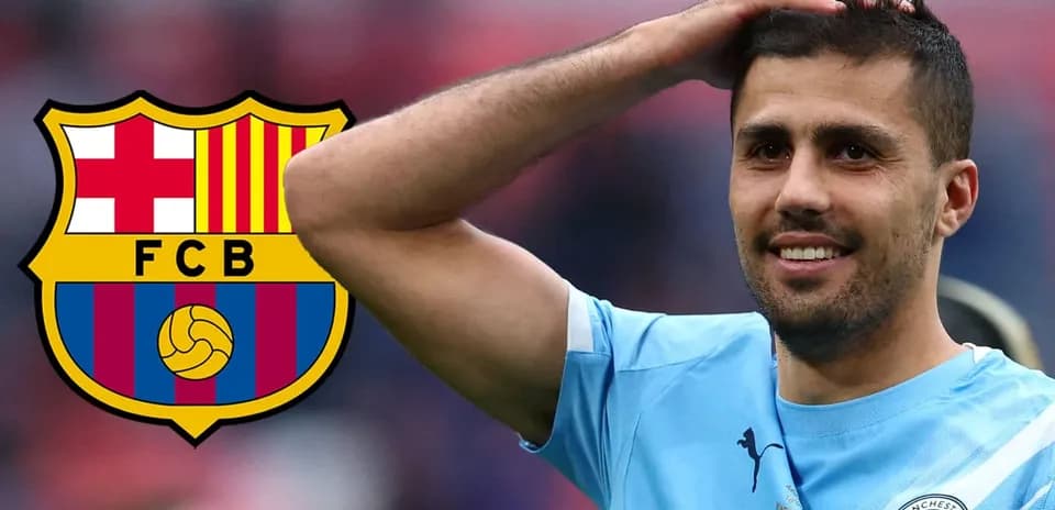 Player smiling with Manchester City kit and Barcelona logo