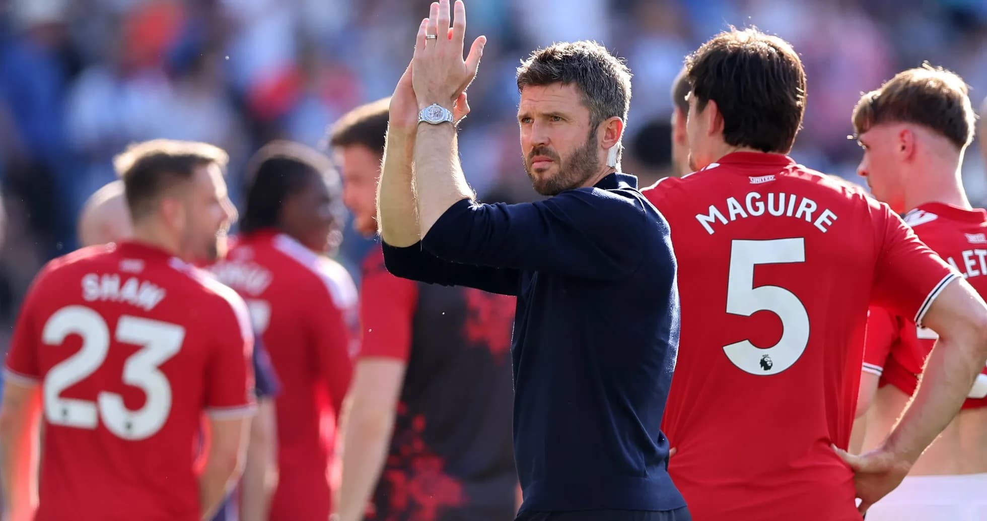 Manager applauding players after match conclusion
