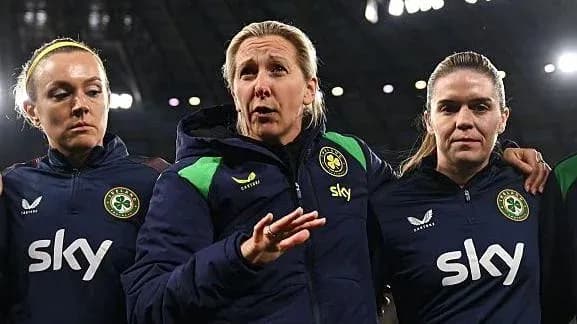 Coach speaking with two players during team discussion