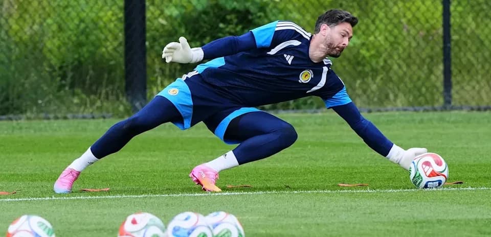 Goalkeeper diving to save a soccer ball during training
