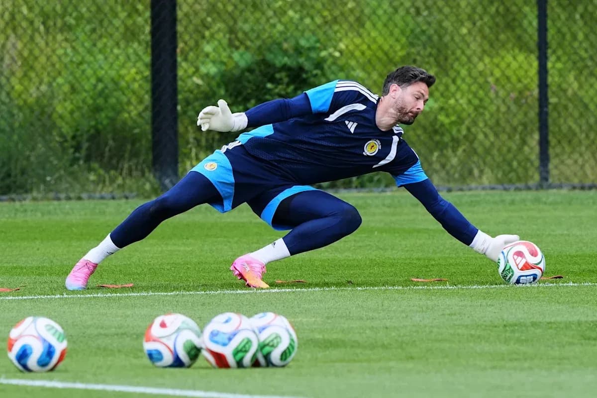 Goalkeeper diving to save a soccer ball during training