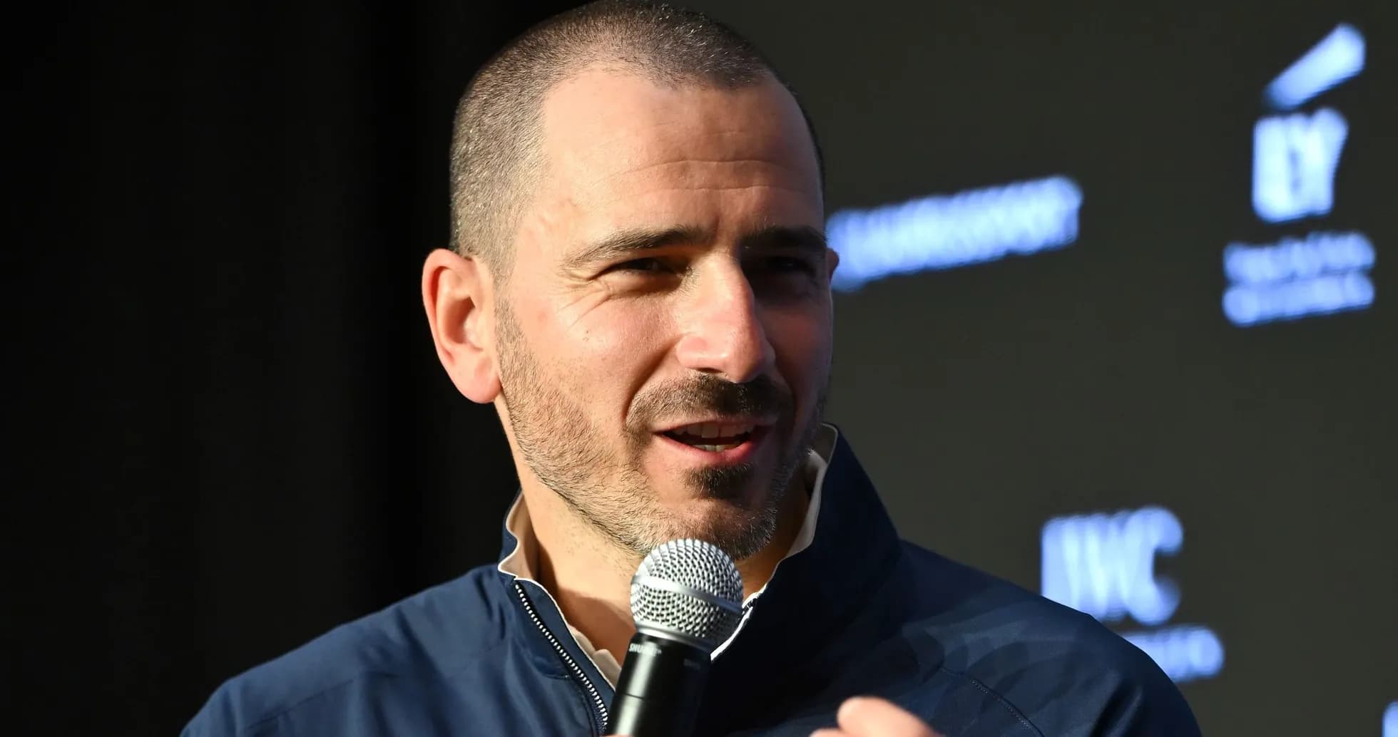 Man speaking into a microphone at event