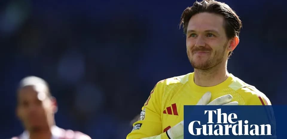 Goalkeeper in yellow kit smiling during match