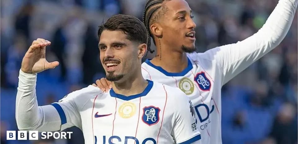 Two Chelsea FC players celebrating on the pitch