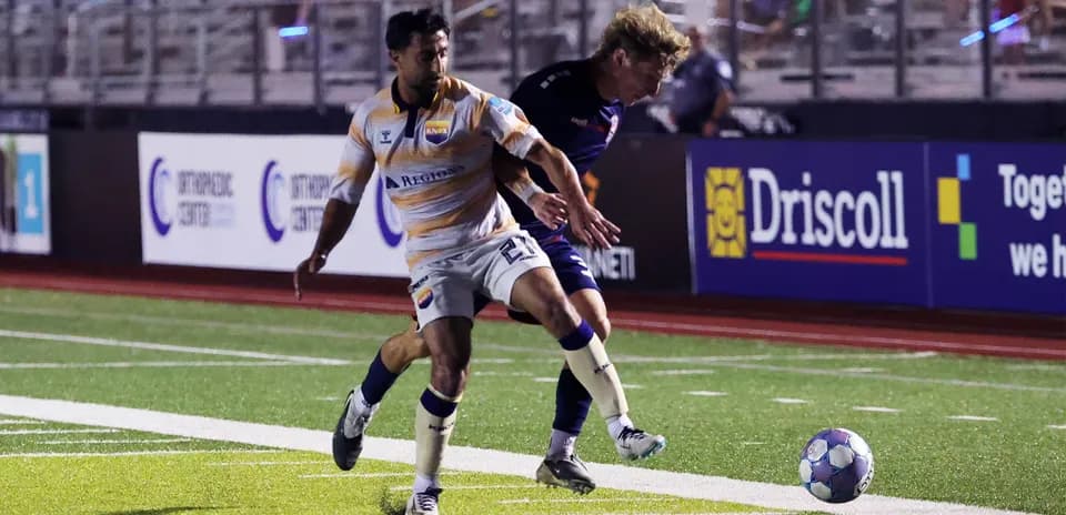 One Knoxville player dribbling the ball against Chattanooga