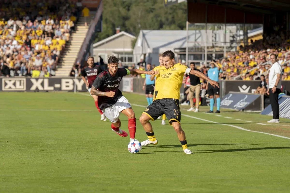 Two players competing for the ball in football match
