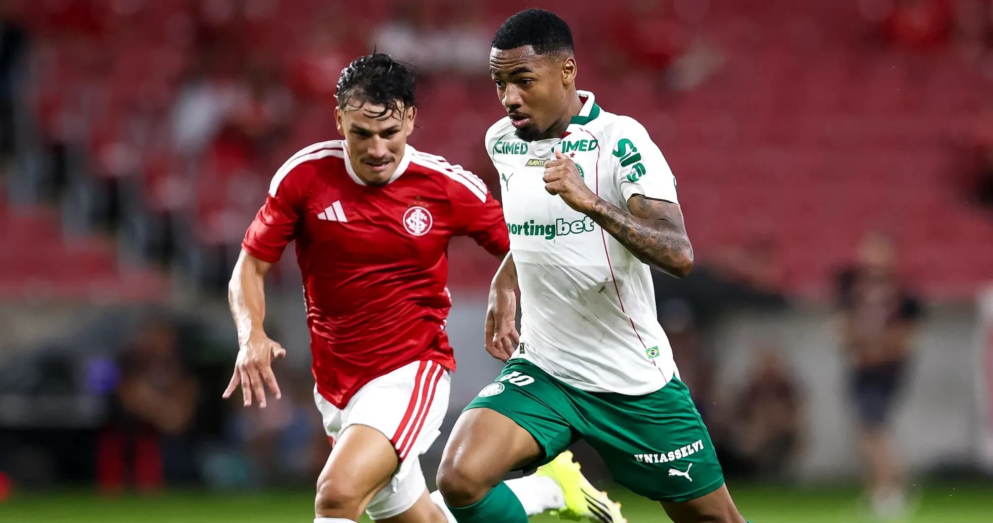 Two players sprinting for the ball during match