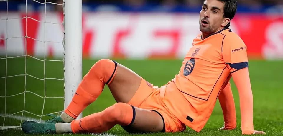 Goalkeeper sitting near goalpost during match