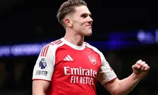 Player celebrating in Arsenal jersey during match