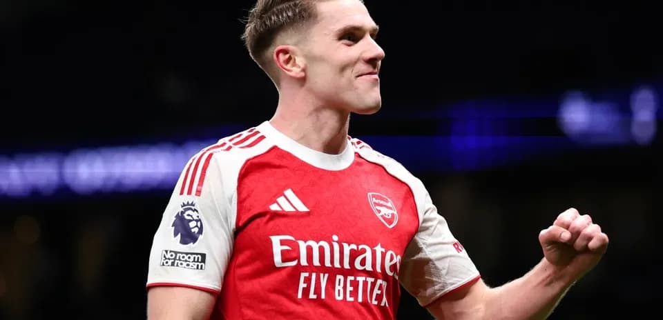 Player celebrating in Arsenal jersey during match