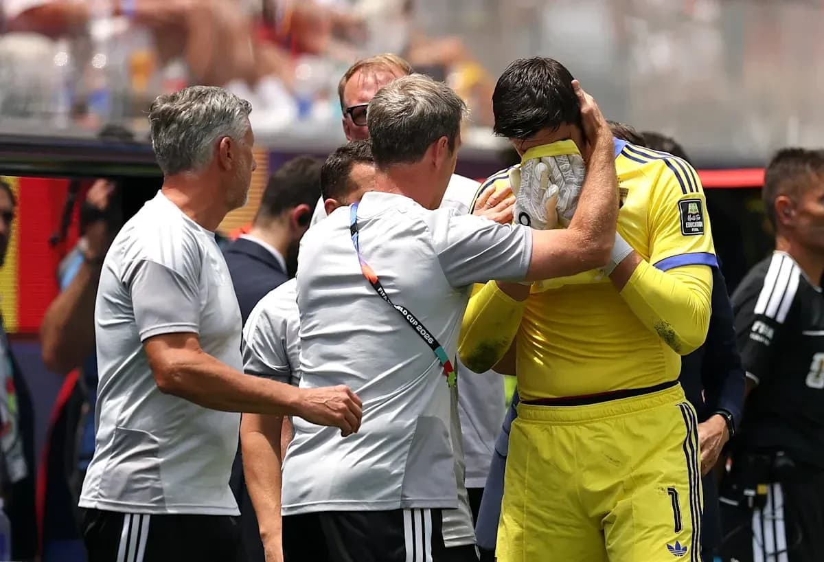 Goalkeeper receiving support from coaches on sidelines