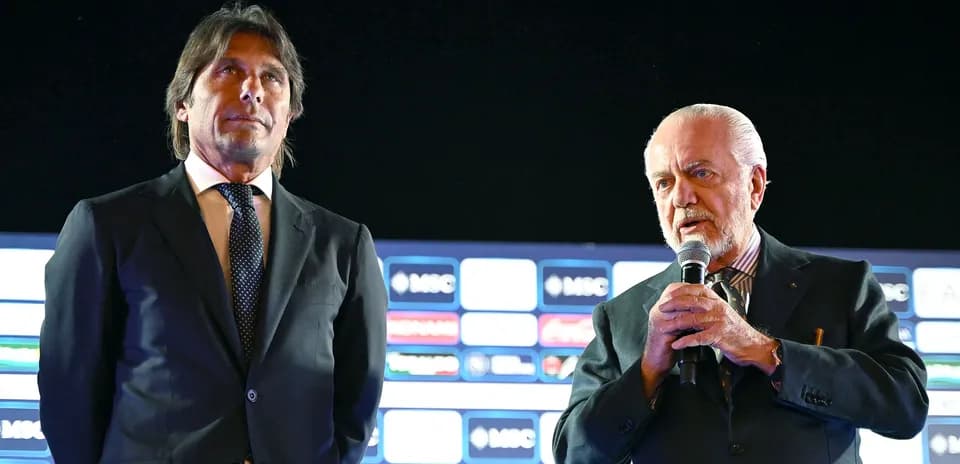 Two men speaking at a press conference event