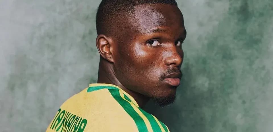 Player wearing yellow jersey looking over shoulder