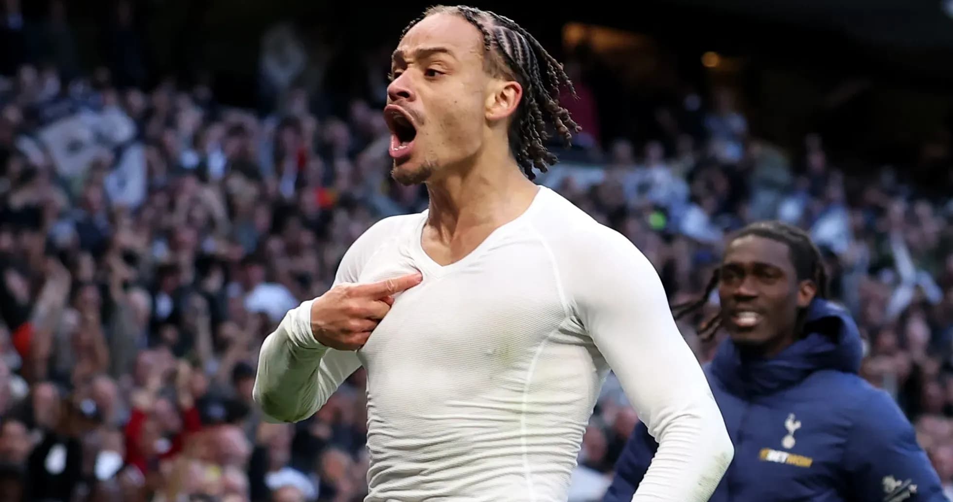 Player celebrating a goal in front of fans