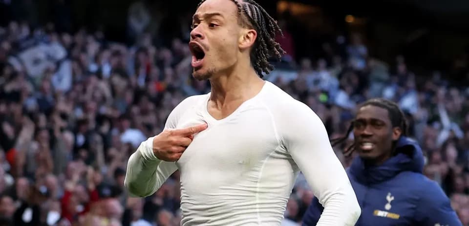 Player celebrating a goal in front of fans