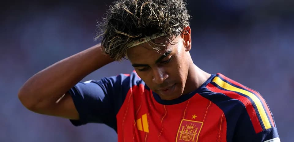 Player in Spain kit looking down during match