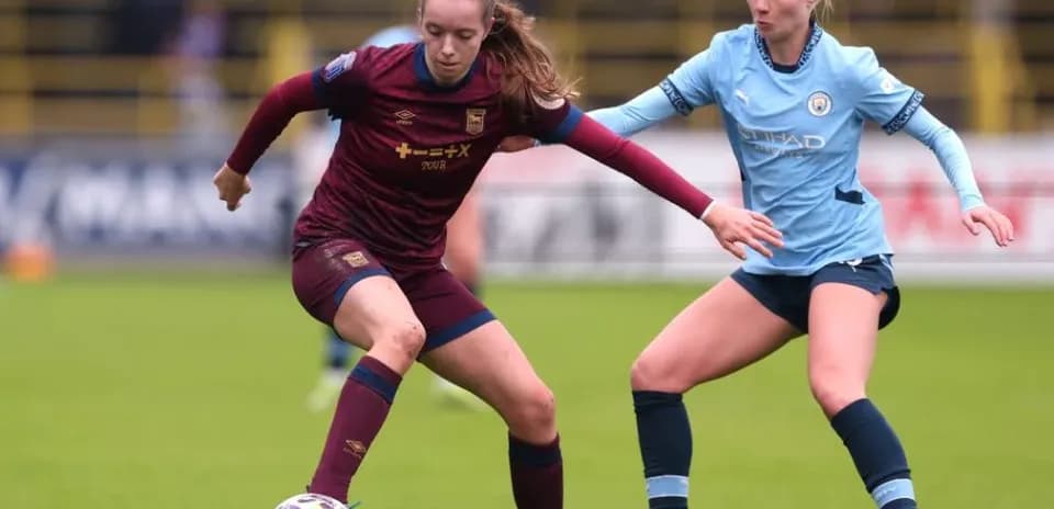 Two female players competing for the ball during match
