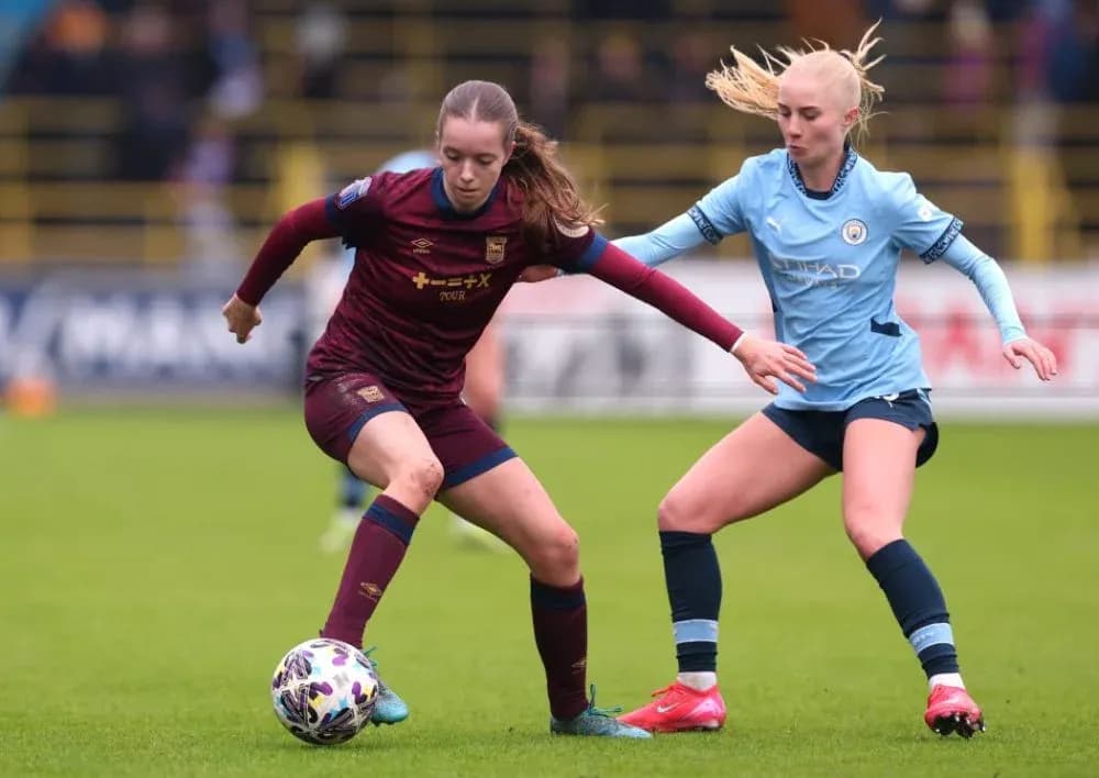 Two female players competing for the ball during match