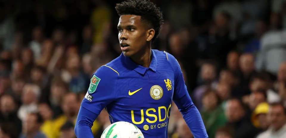 Player in blue kit holding a football during match