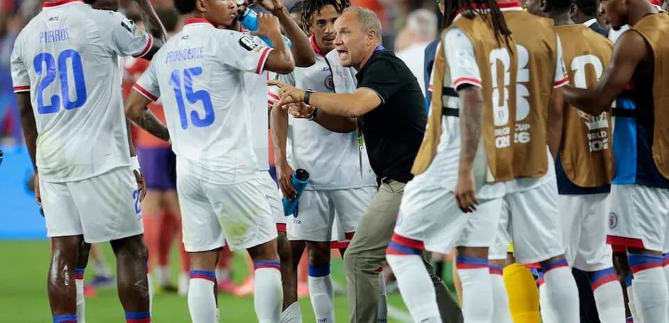 Haiti players discussing strategy during a match