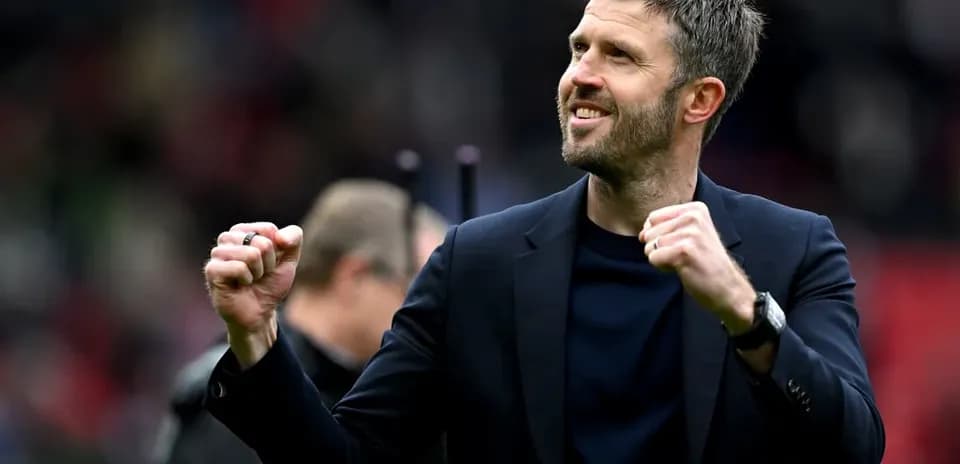 Coach celebrating with clenched fist on the sidelines
