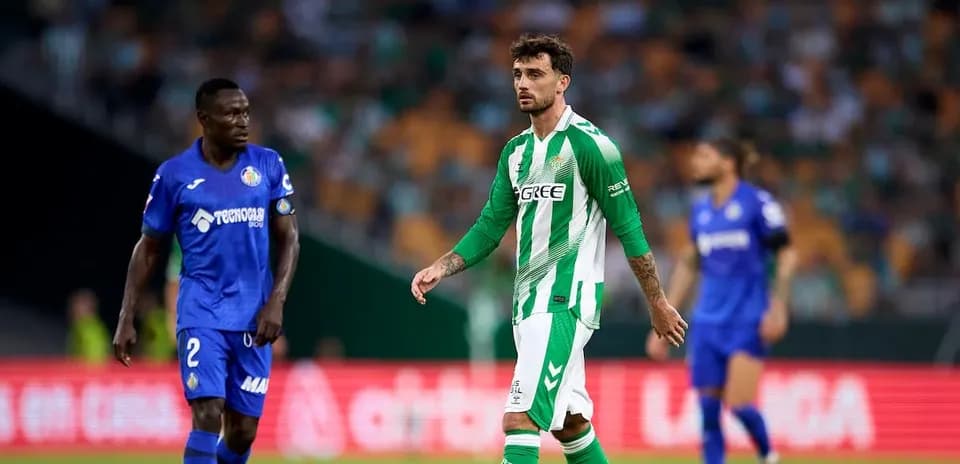Two players on the pitch during match action