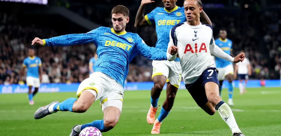 Wolves player tackling Tottenham player during match