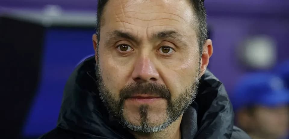 Coach observing from the sidelines during match