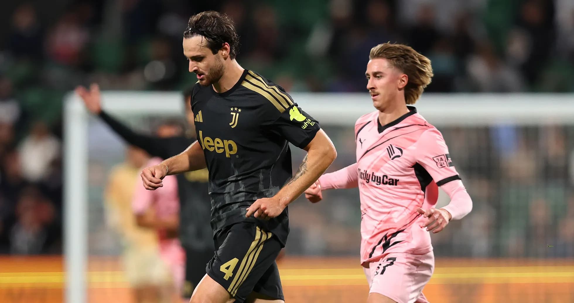 Juventus player running with ball pursued by opponent