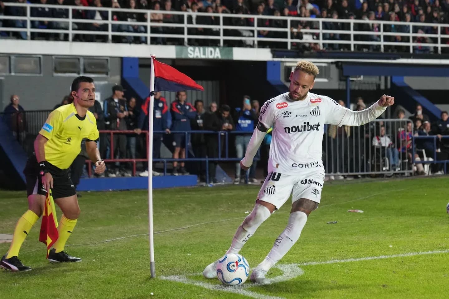Player taking a corner kick near the flag