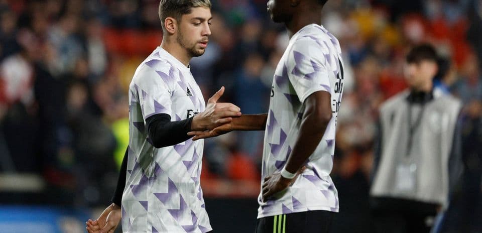 Two Real Madrid players exchanging gestures on field