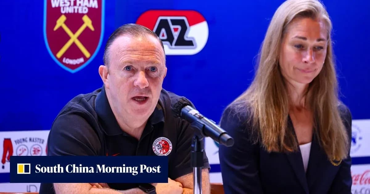 Man speaking at press conference with woman beside him