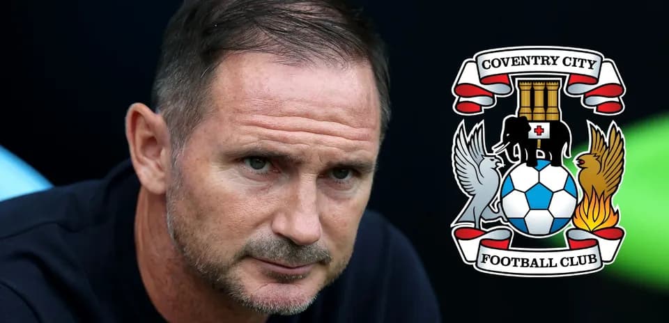 Coach seated with Coventry City logo in background
