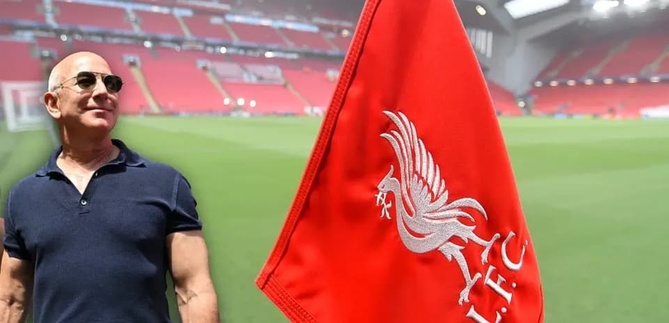 Person standing beside Liverpool FC corner flag at stadium
