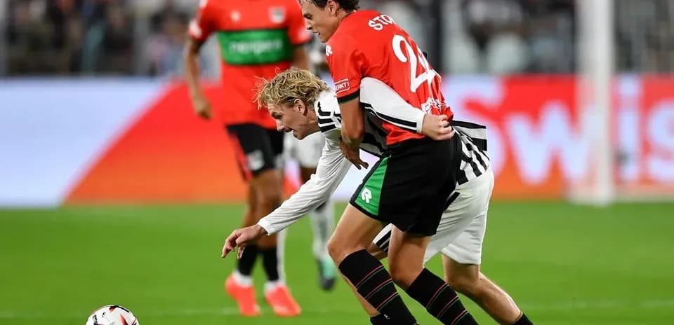 Players contesting possession during a soccer match