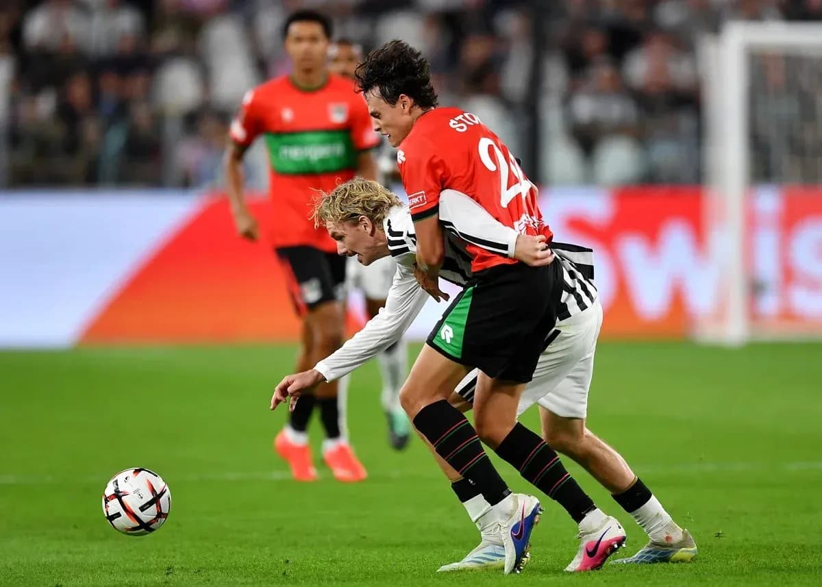 Players contesting possession during a soccer match