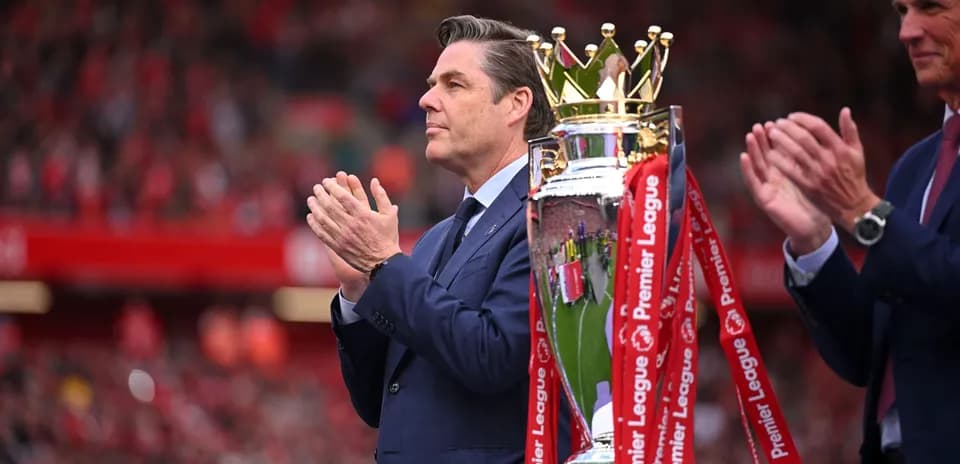 Man applauding near Premier League trophy presentation