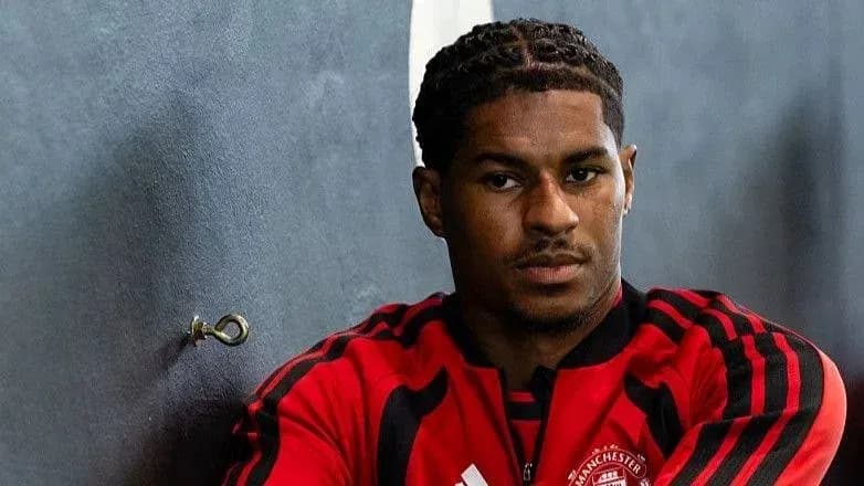 Player in Manchester United training kit posing