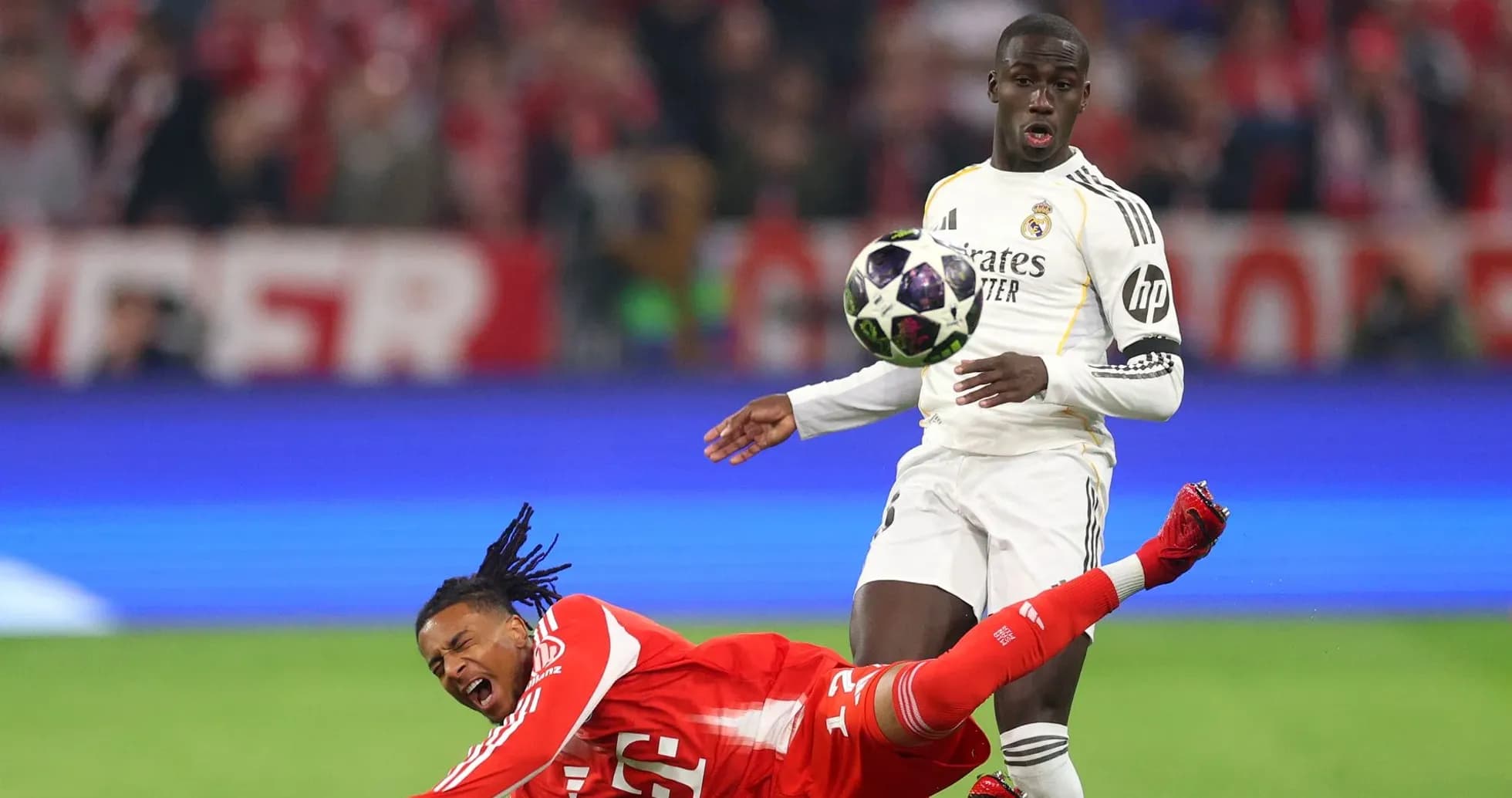 Player falling while opponent prepares to kick ball