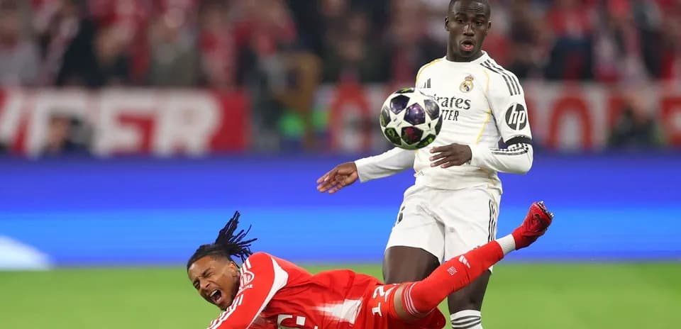 Player falling while opponent prepares to kick ball