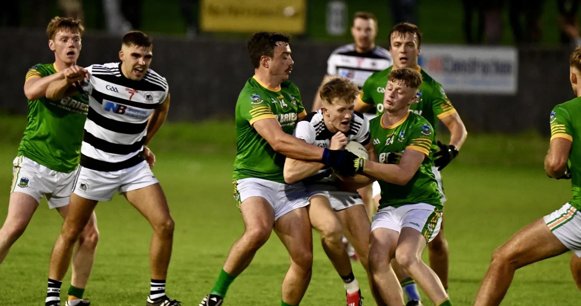 Players competing for possession during Gaelic football match