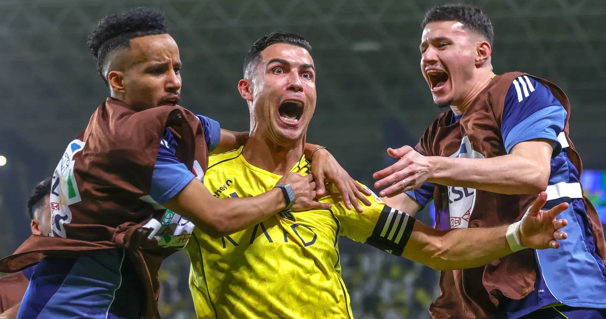 Players celebrating a goal on the field