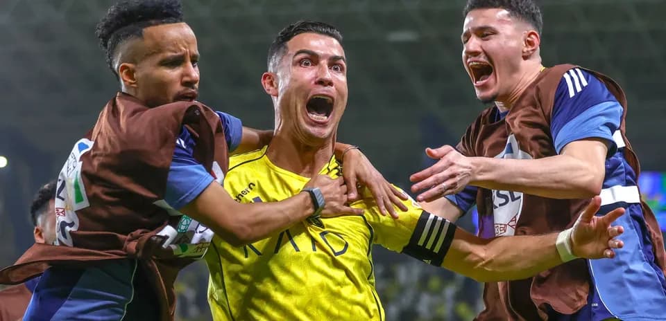 Players celebrating a goal on the field